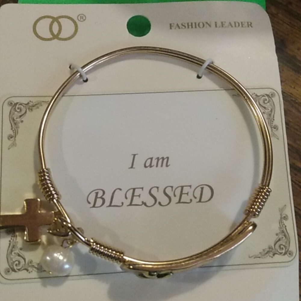 Beautiful gold bracelet ( blessed) with charms pearl and cross .. gold